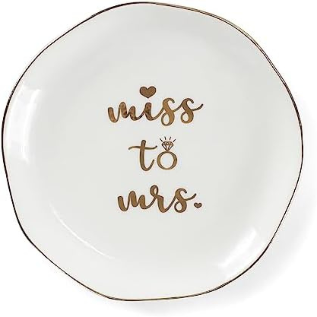 White “Miss to Mrs” ceramic ring dish with gold trim—perfect for keeping jewelry safe on wedding morning.