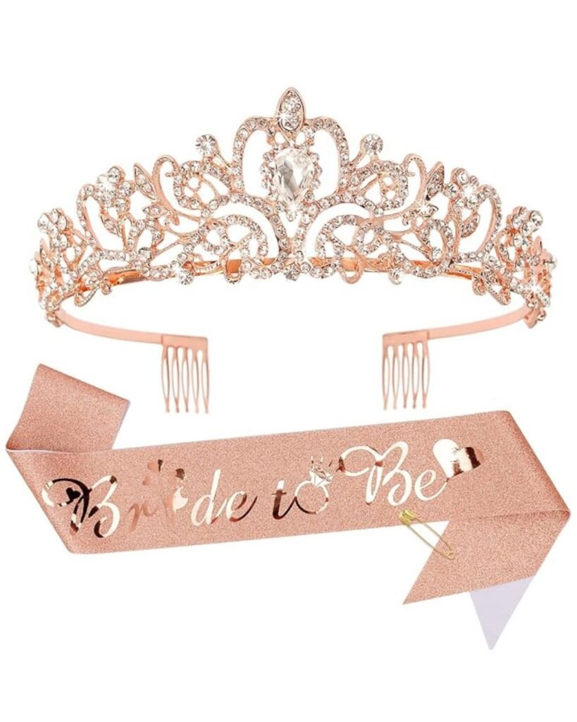 “Bridal party toasting glasses accessories: rose-gold rhinestone tiara with scrollwork and matching ‘Bride to Be’ sash”