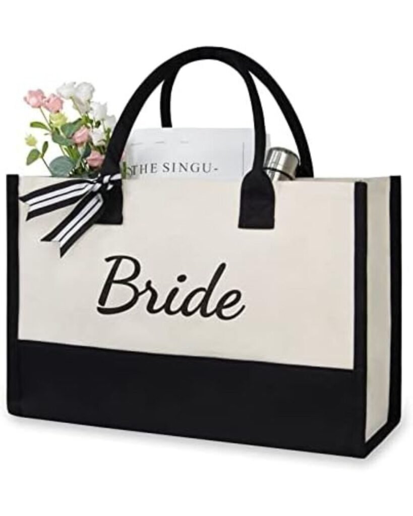 “Bride canvas tote bag for picture-perfect wedding prep, black-and-cream with ‘Bride’ script and striped ribbon accent.”