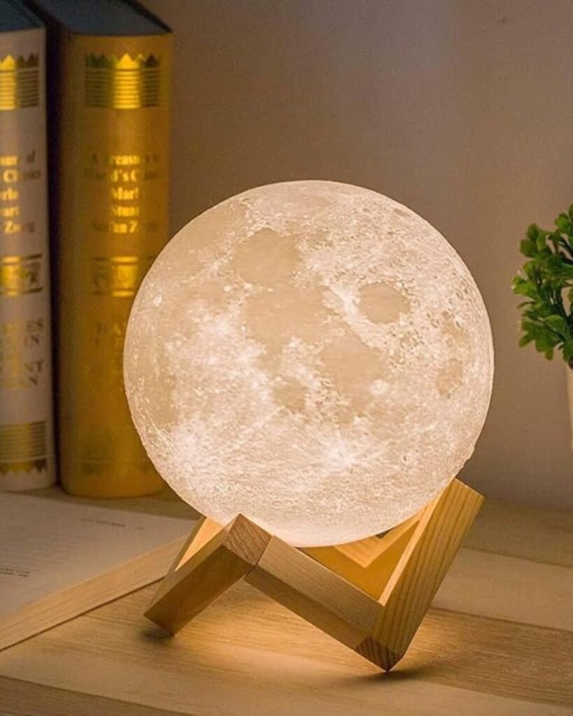Soft glowing moon lamp on a wooden base, a cozy bedroom essential for warm ambient lighting and relaxing nighttime vibes.

