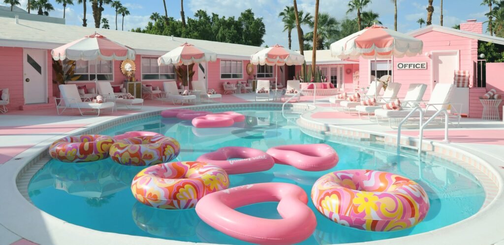 Pink heart-shaped floats bobbing in the retro pool at Trixie Motel Palm Springs