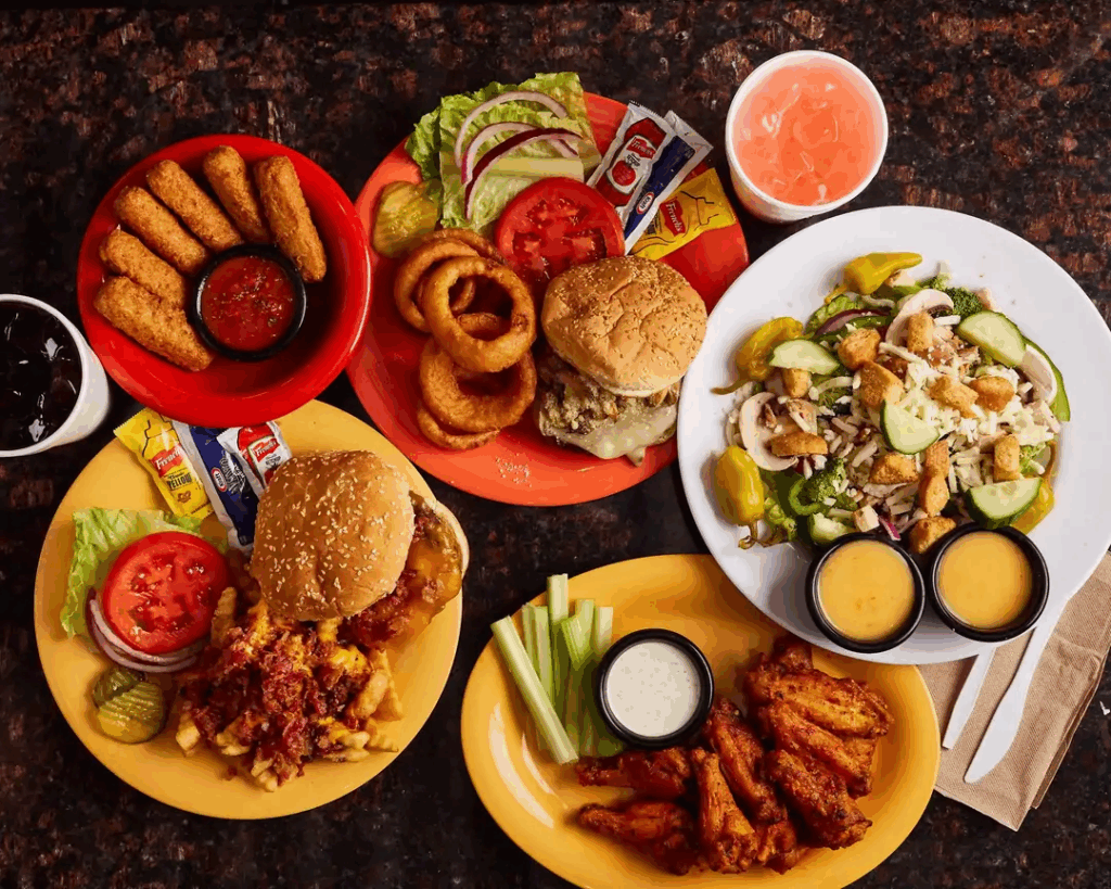 Plates of burgers, wings, salad, and fried appetizers served at Silver Sands Cafe in Nashville, Tennessee.