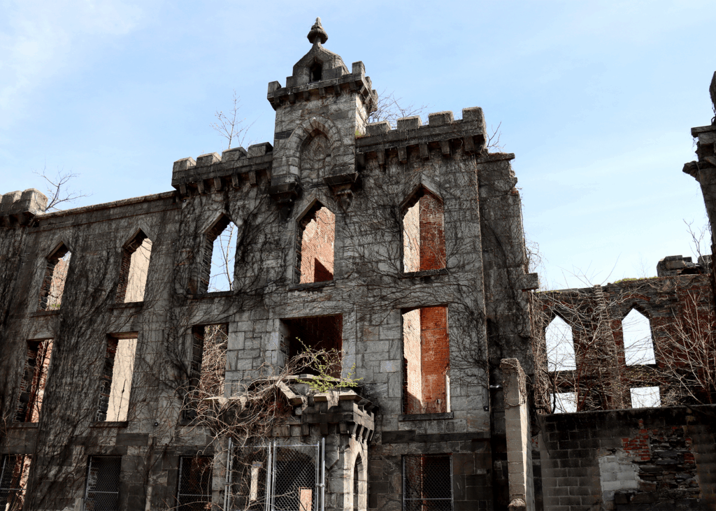 Historic stone walls of the Roosevelt Island Smallpox Ruins with exposed brick and Gothic arches in New York.
