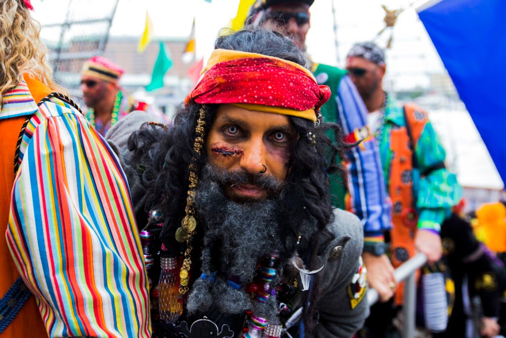 Pirate in full costume with beads and headscarf at the Gasparilla Pirate Festival in Tampa, Florida.