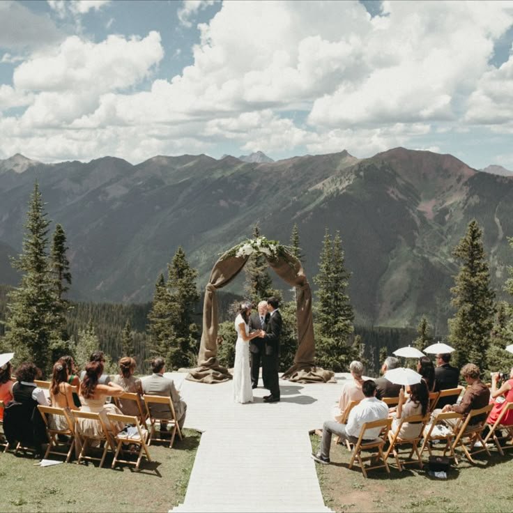 Bride and groom exchanging vows at an intimate mountaintop wedding in Colorado with breathtaking Rocky Mountain views.