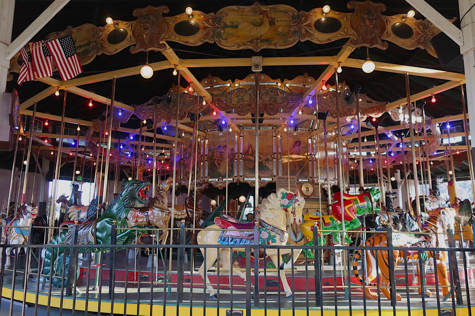 Colorful Looff Carousel San Diego with lion, tiger, and horse figures at Balboa Park
