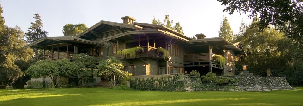 The Gamble House Pasadena California exterior view with lush garden and historic Arts and Crafts architecture.