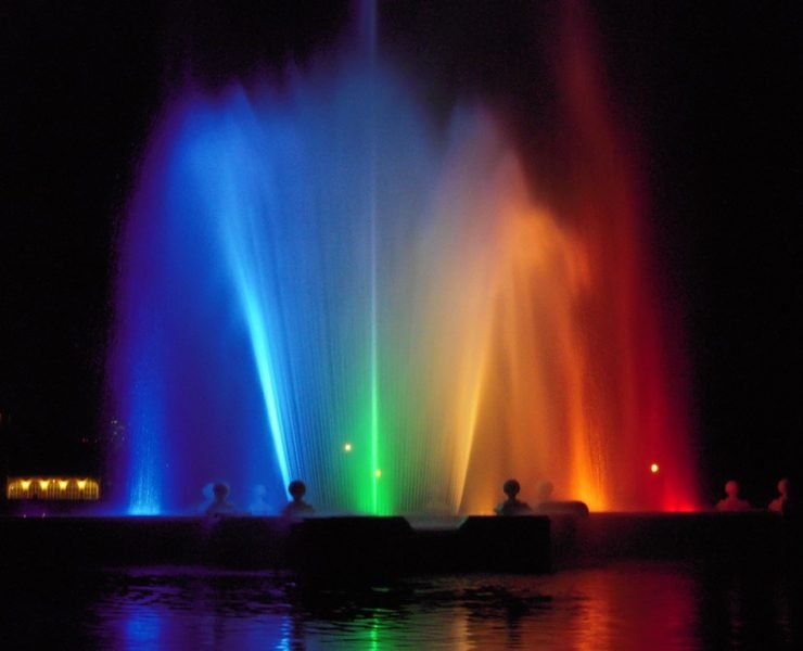 Prismatic Electric Fountain in Denver lit up with rainbow colors at night