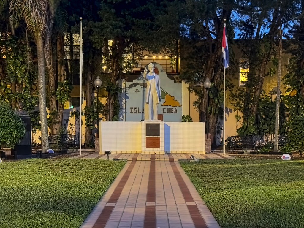 Statue of Jose Marti at night in Jose Marti Park Tampa with Cuban flag