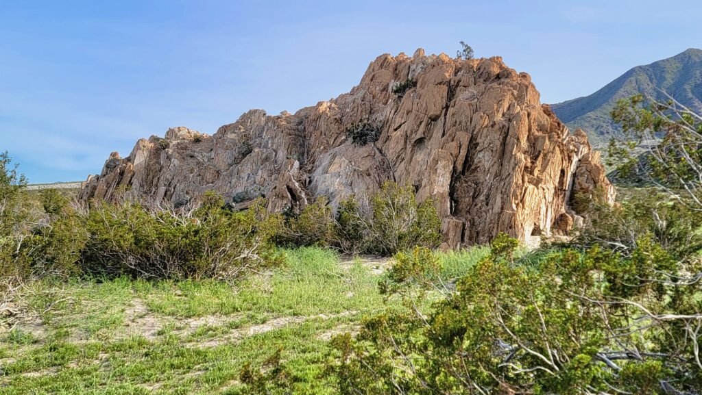 The natural rock formation known as Shiprock in Palm Springs, California, surrounded by desert vegetation