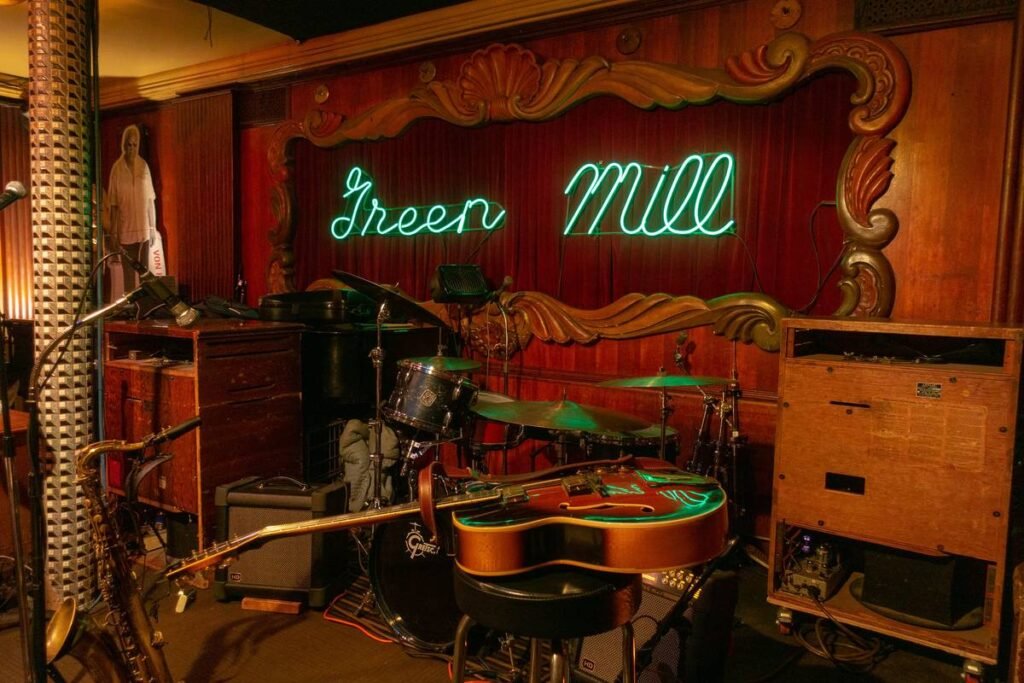 Stage at Green Mill Chicago with neon sign and jazz instruments ready for live music.