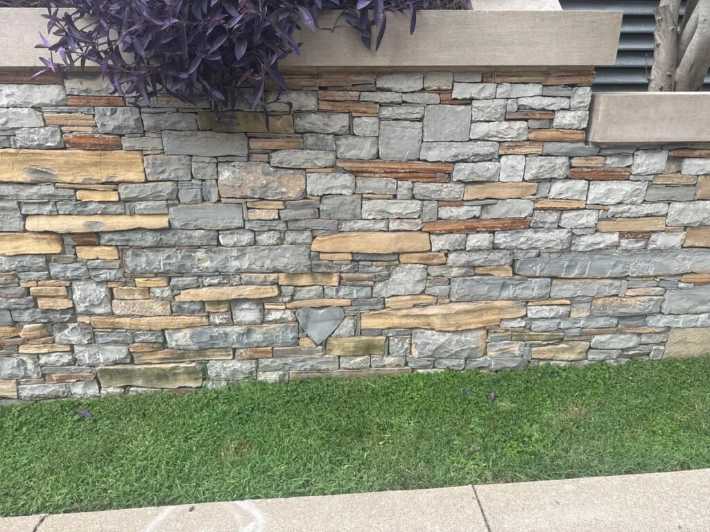 Stone wall in Nashville with a hidden heart-shaped rock among the bricks.