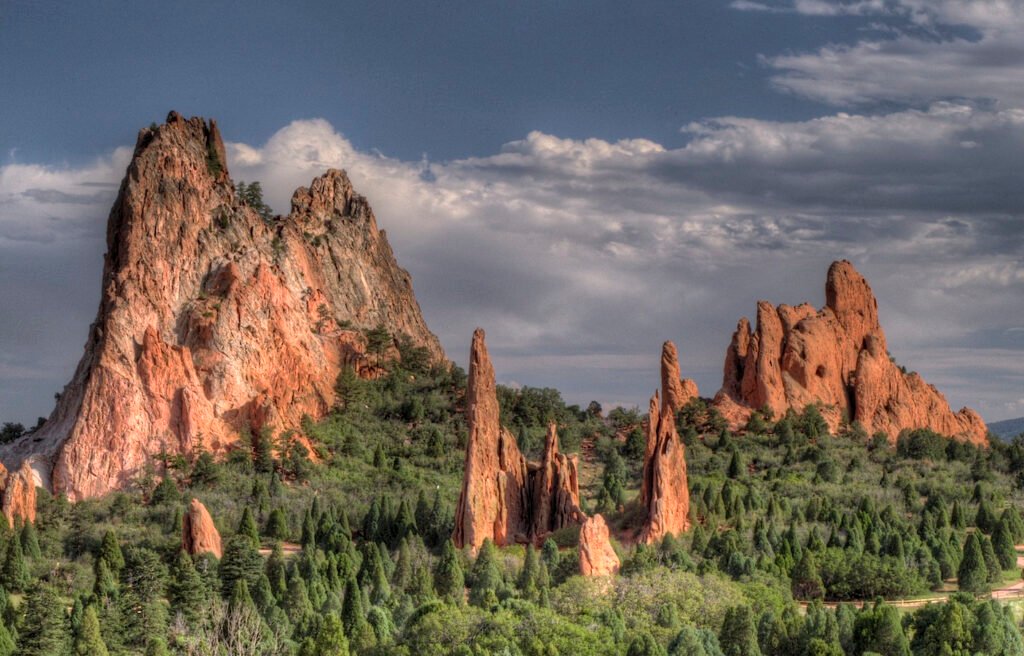 Towering red rock formations at Garden of the Gods in Colorado Springs under dramatic sky.