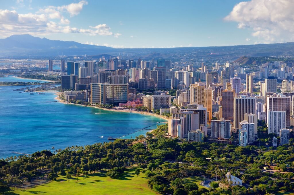 Sunny beach with resorts and crystal-clear water on the Big Island of Hawaii.