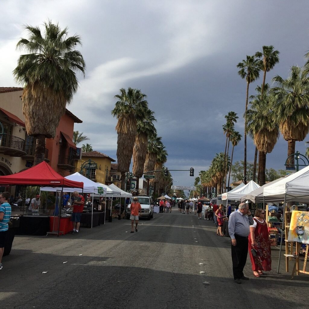 Outdoor café and seating area with palm trees at Market Market in Palm Springs