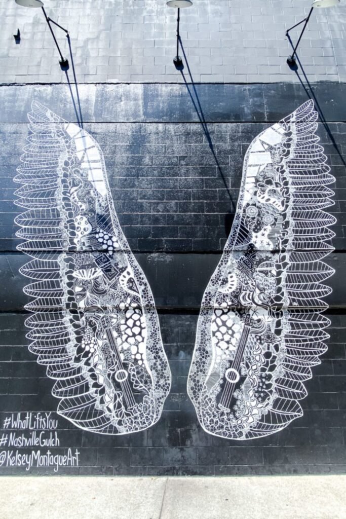 Famous #WhatLiftsYou angel wings mural in The Gulch, Nashville — a popular photo spot and symbol of creativity in Family-Friendly Nashville.