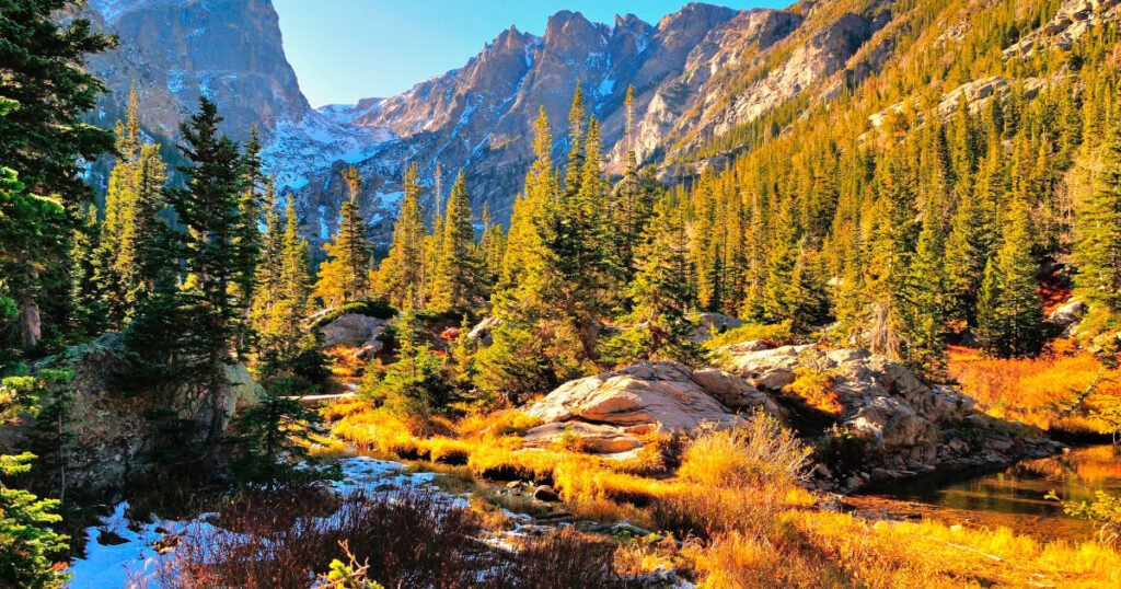 Golden light shining over the mountains and forest in Rocky Mountain National Park, Colorado.