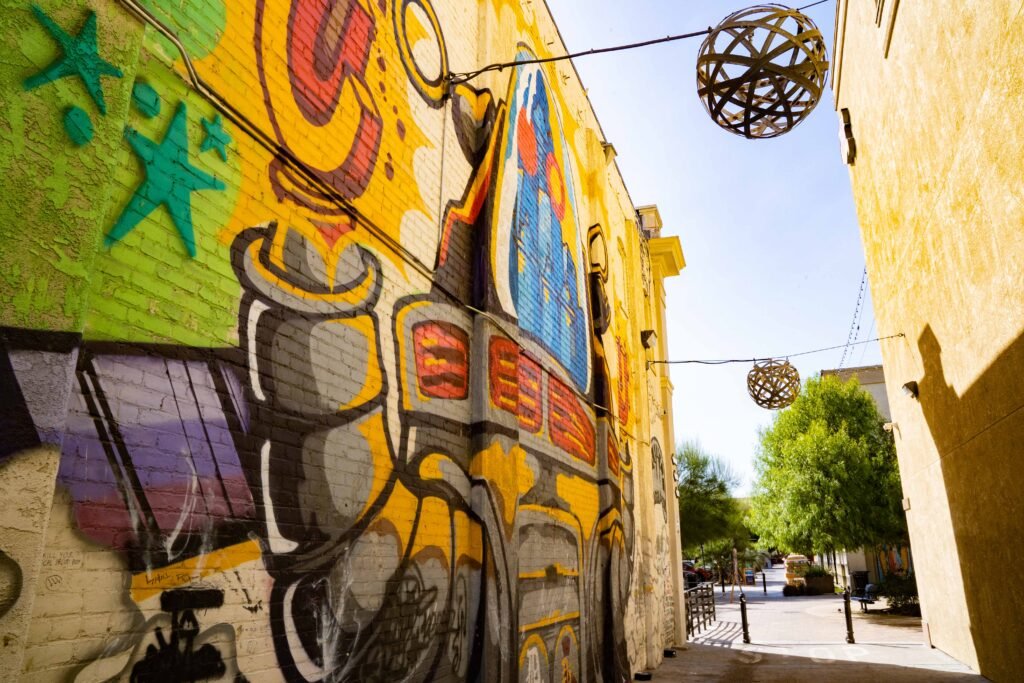 Vibrant street mural in Santa Ana’s Arts District with hanging lights and creative atmosphere.