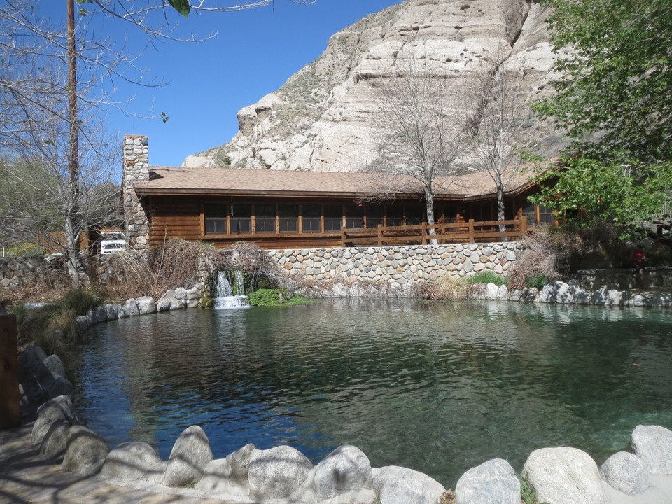 Mountain lodge and pond surrounded by desert cliffs at Whitewater Preserve Palm Springs