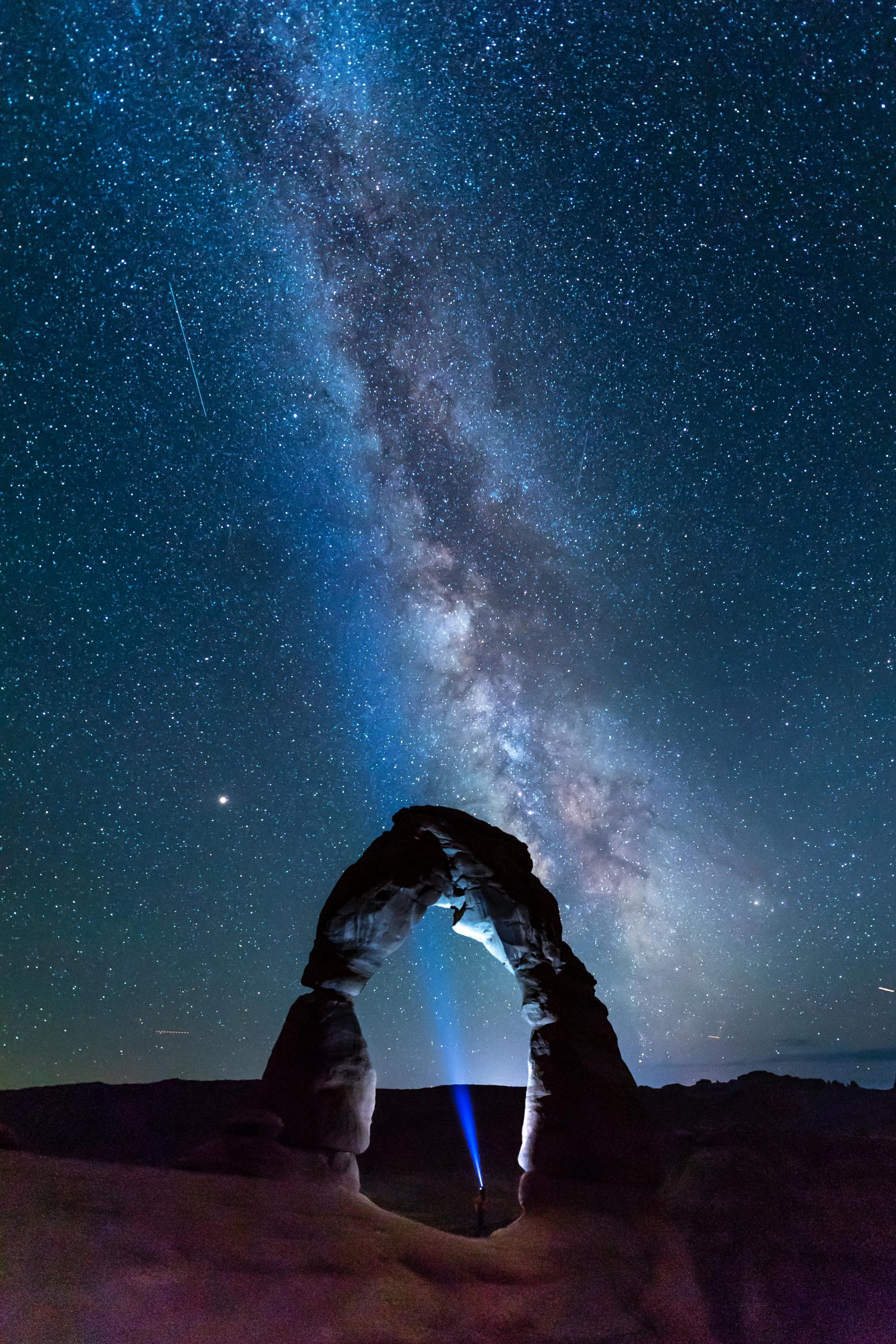 Milky Way over a desert rock arch during a clear night in Palm Springs, perfect for desert stargazing.