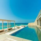 architectural photography of gray granite swimming pool and outdoor lounge at beach side