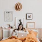 woman using laptop in bed
