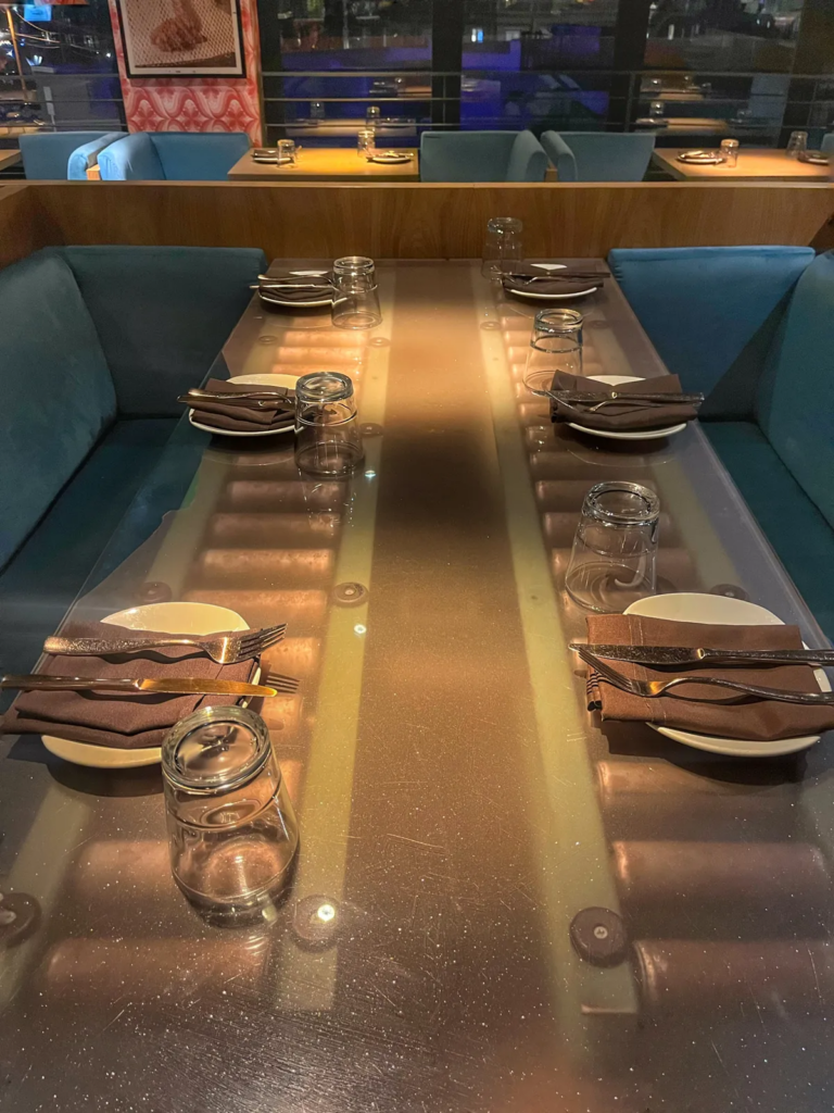 Indoor table setup at Linger Eatuary in Denver with modern decor and cozy seating