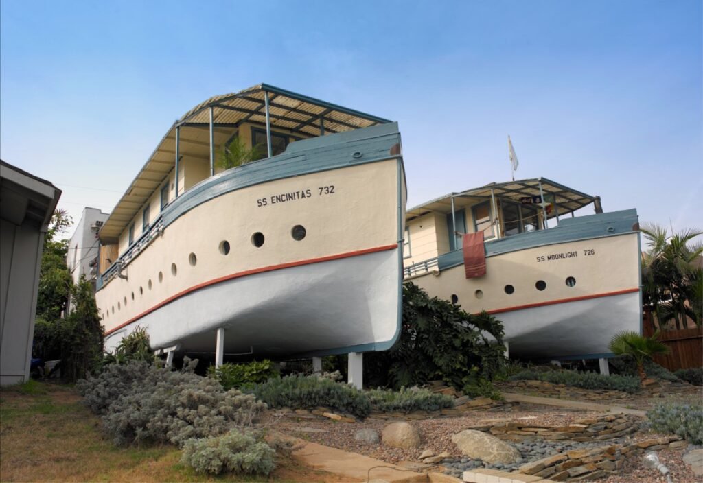 Side view of the Encinitas Boat Houses—SS Encinitas 732 and SS Moonlight 726—land-locked, ship-shaped cottages on 3rd Street in Encinitas, California.