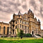 Gothic limestone façade of Old Tennessee State Prison Nashville under a dramatic cloudy sky