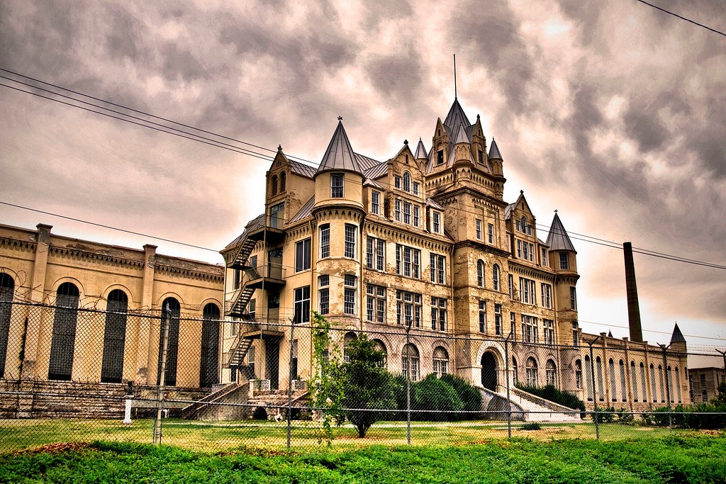 Gothic limestone façade of Old Tennessee State Prison Nashville under a dramatic cloudy sky