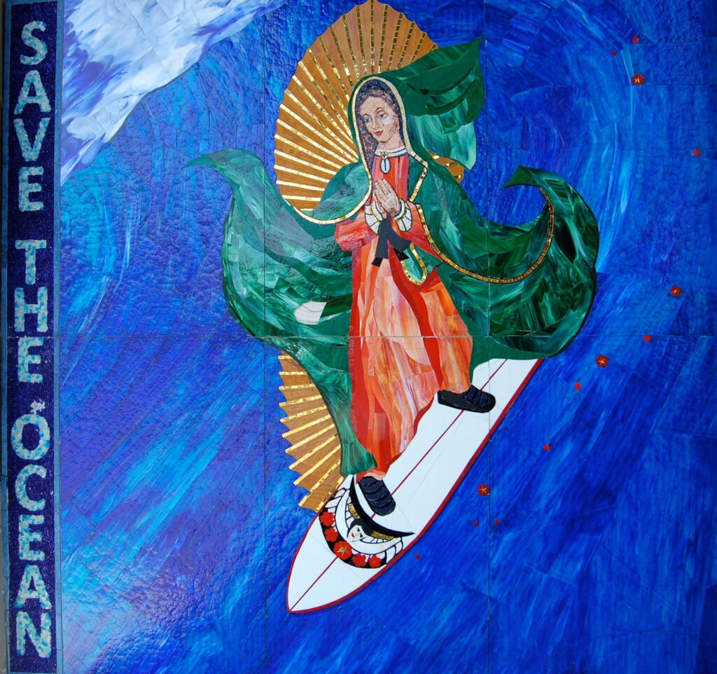 Close-up of the Surfing Madonna mosaic showing the Virgin of Guadalupe surfing beside the words “Save the Ocean”.