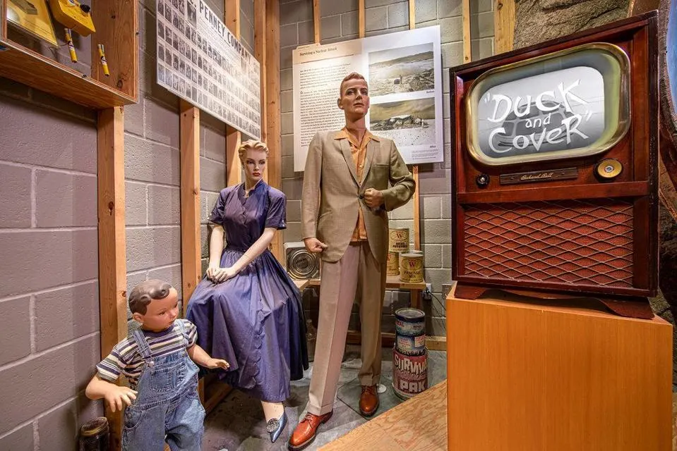 	1950s “Duck and Cover” civil-defense diorama with mannequins and vintage TV inside the Atomic Museum Las Vegas.