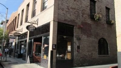 Street view of Kendall Alley in Pasadena, featuring vintage brick buildings and the cozy alleyway entrance to local shops and cafes.