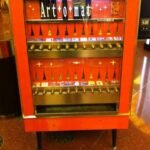 Artomat Vegas vending machine inside the Cosmopolitan Hotel—vintage red cabinet selling pocket-size art for five dollars