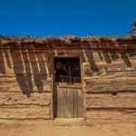Flying V Cabin Phoenix exterior—1880 log walls, half-door and desert sky at Pioneer Living History Museum