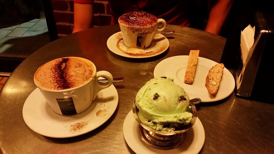 Caffe Vittoria Boston cappuccinos, biscotti and mint-chip gelato on a round metal table