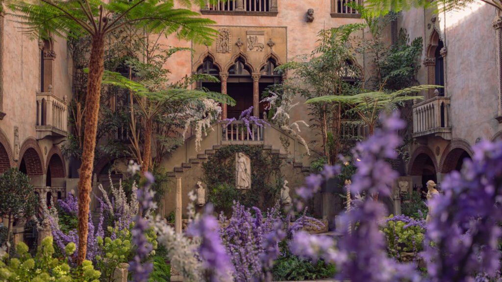 Gardner Museum Boston courtyard bursting with purple wisteria and marble statues