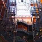 Bradbury Building Los Angeles atrium—wrought-iron staircases reaching up to a soaring glass skylight