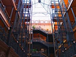Bradbury Building Los Angeles atrium—wrought-iron staircases reaching up to a soaring glass skylight