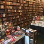 Wooden ladder and crime-novel displays at Mysterious Bookshop New York, showing rows of classic and modern whodunits