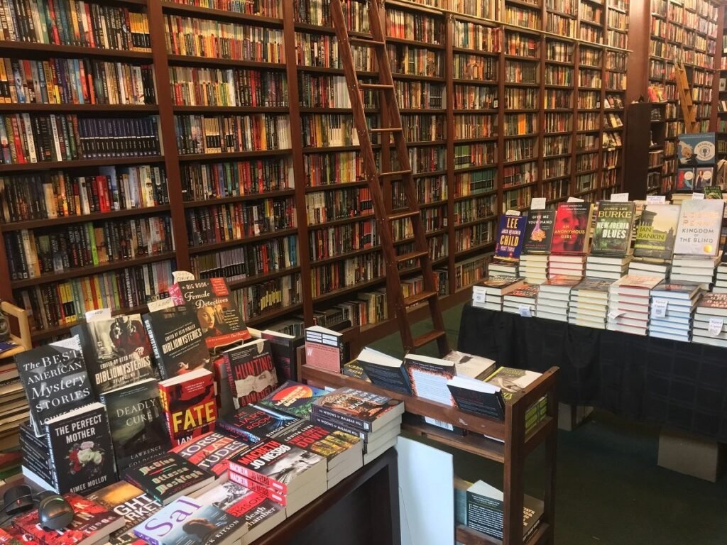 Wooden ladder and crime-novel displays at Mysterious Bookshop New York, showing rows of classic and modern whodunits