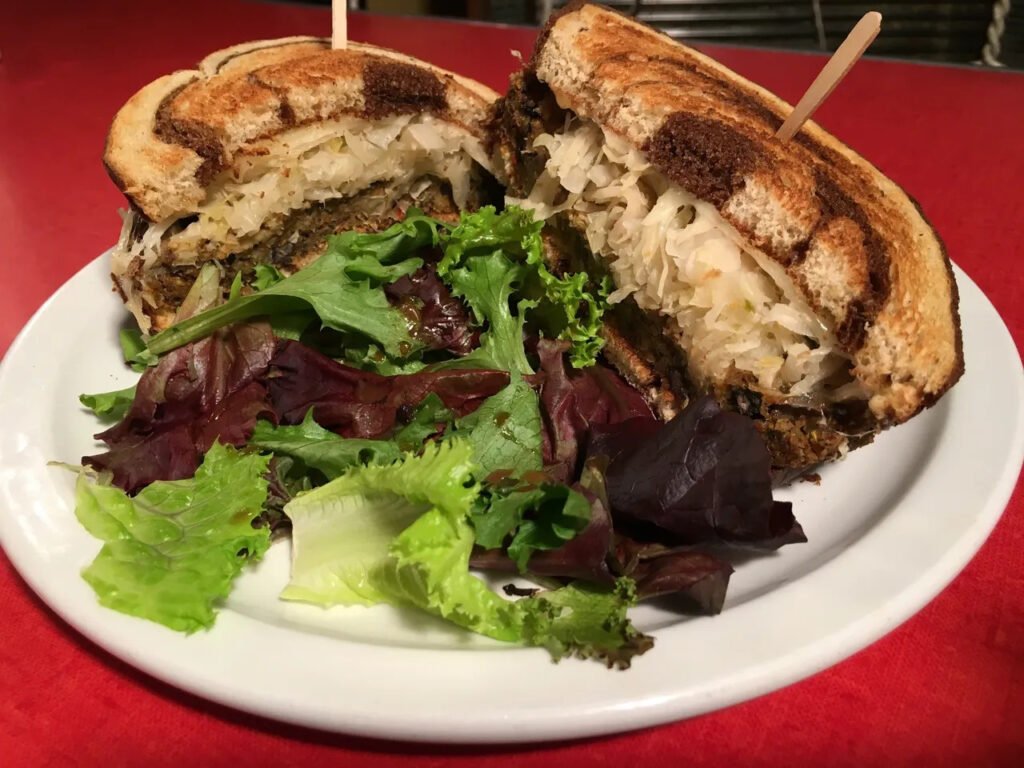 Veggie Reuben sandwich with sauerkraut on marbled rye, served with mixed greens at MacAlpine’s Soda Fountain Phoenix.
