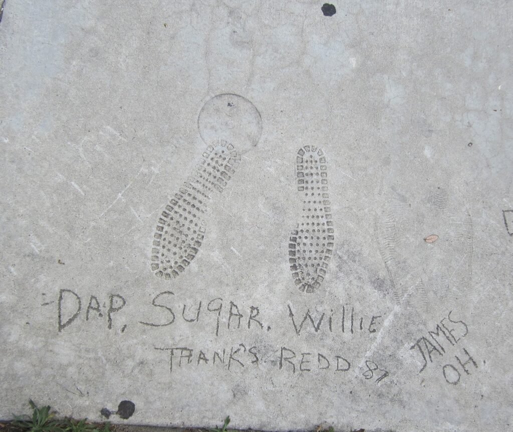 Boot-print impressions from comedian Dap 'Sugar' Willie etched into the sidewalk at the Redd Foxx Walk of Fame, West Hollywood