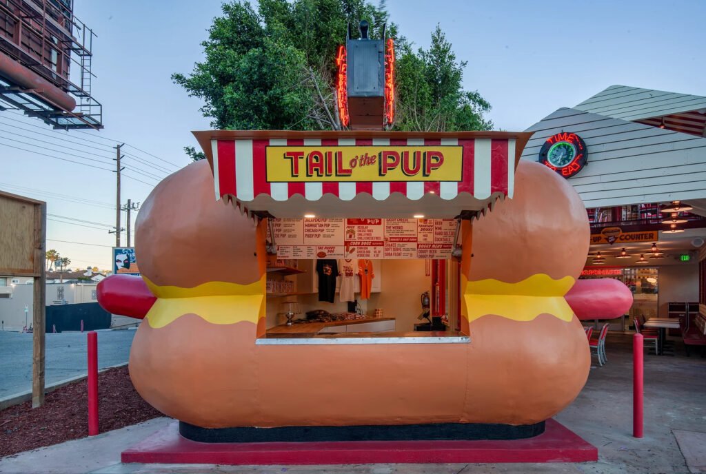 Front view of Tail O’ the Pup’s iconic hot-dog-shaped facade and open service window