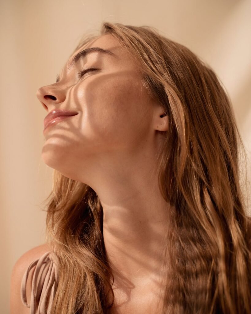 Woman with sun-kissed skin and natural glow from self tanning products