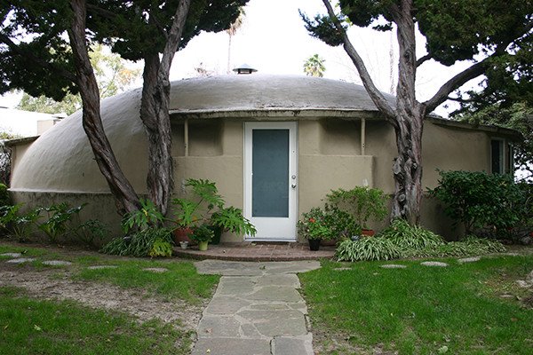 Front view of the original 1946 Bubble House Pasadena framed by cypress trees
