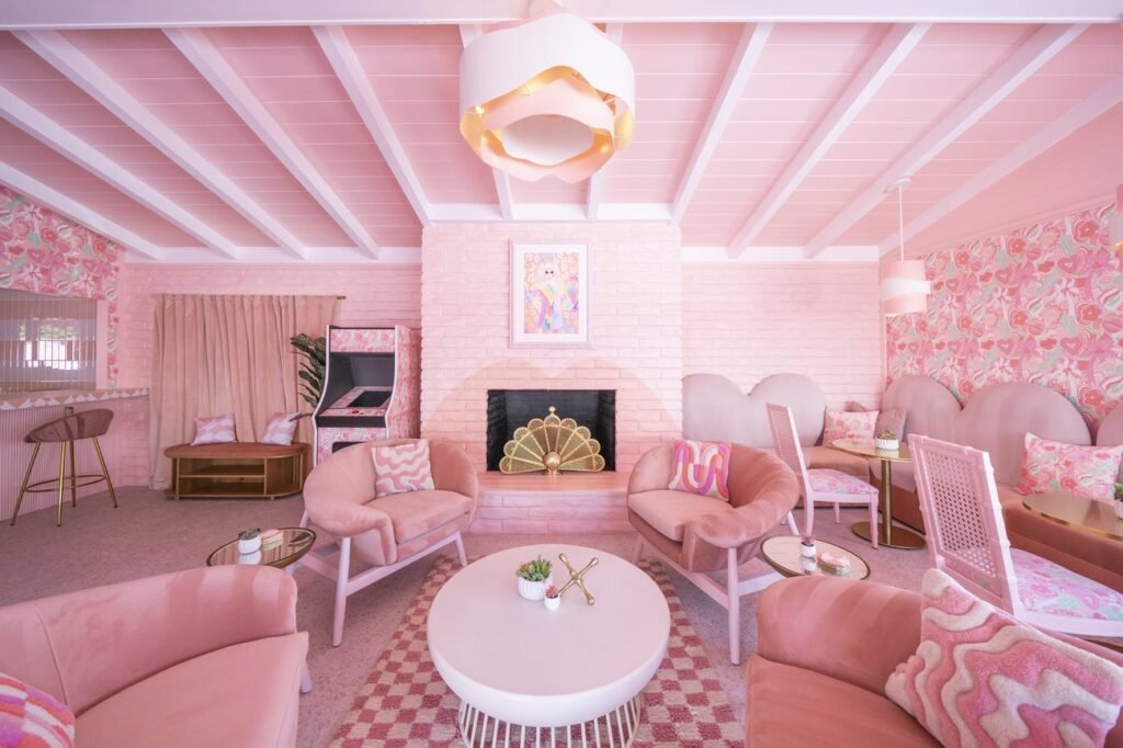 Blush-toned lobby lounge with vintage furniture at Trixie Motel Palm Springs