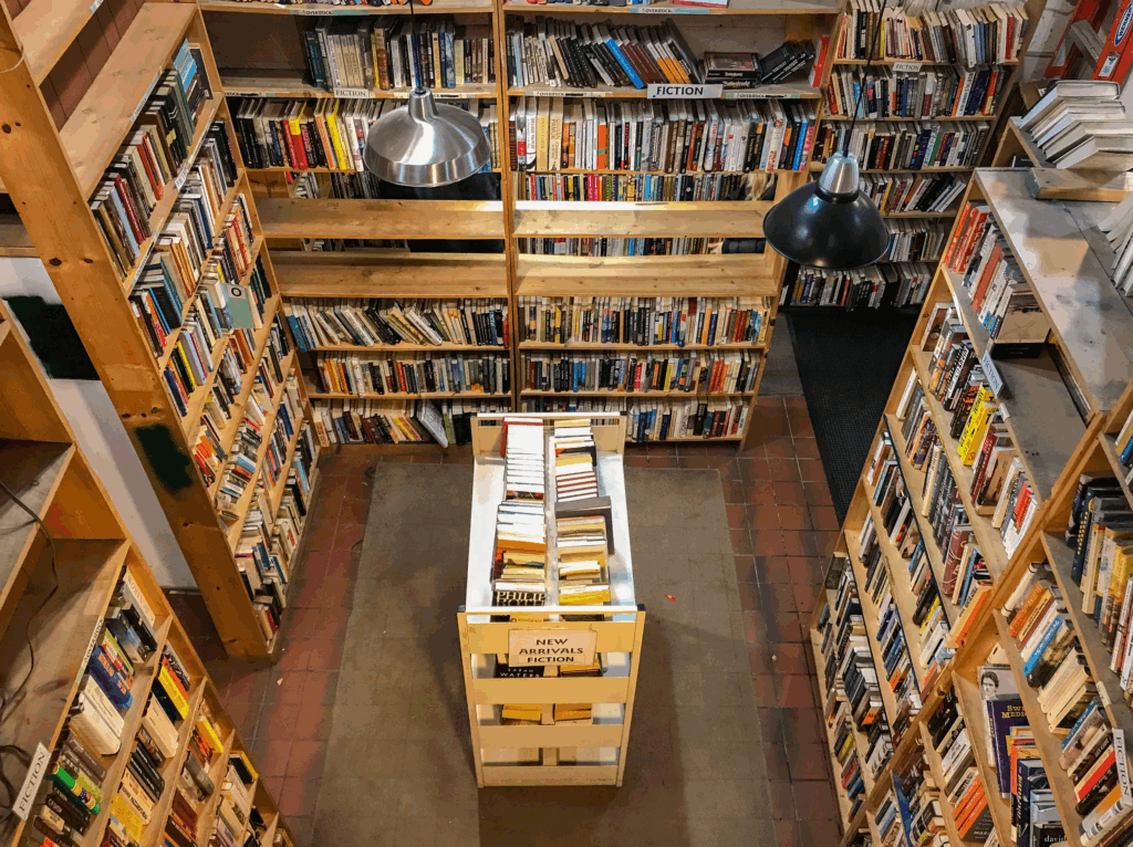 Interior of Myopic Books Chicago with tall wooden bookshelves filled with used books