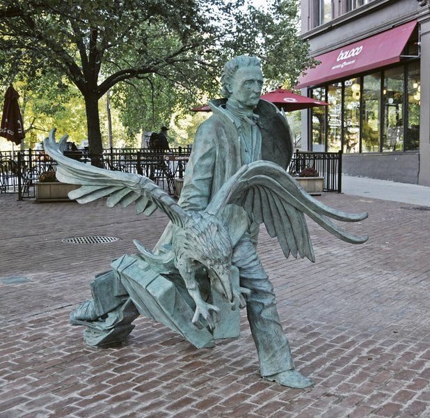 Bronze statue of Edgar Allan Poe with raven at Poe Square Boston near Boylston Street.
