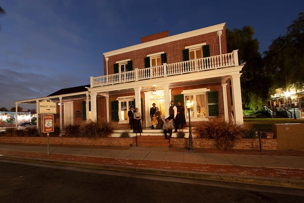 Whaley House San Diego at night with costumed actors during a ghost tour in Old Town.